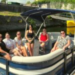 group on blue and white 11 passenger pontoon boat rental