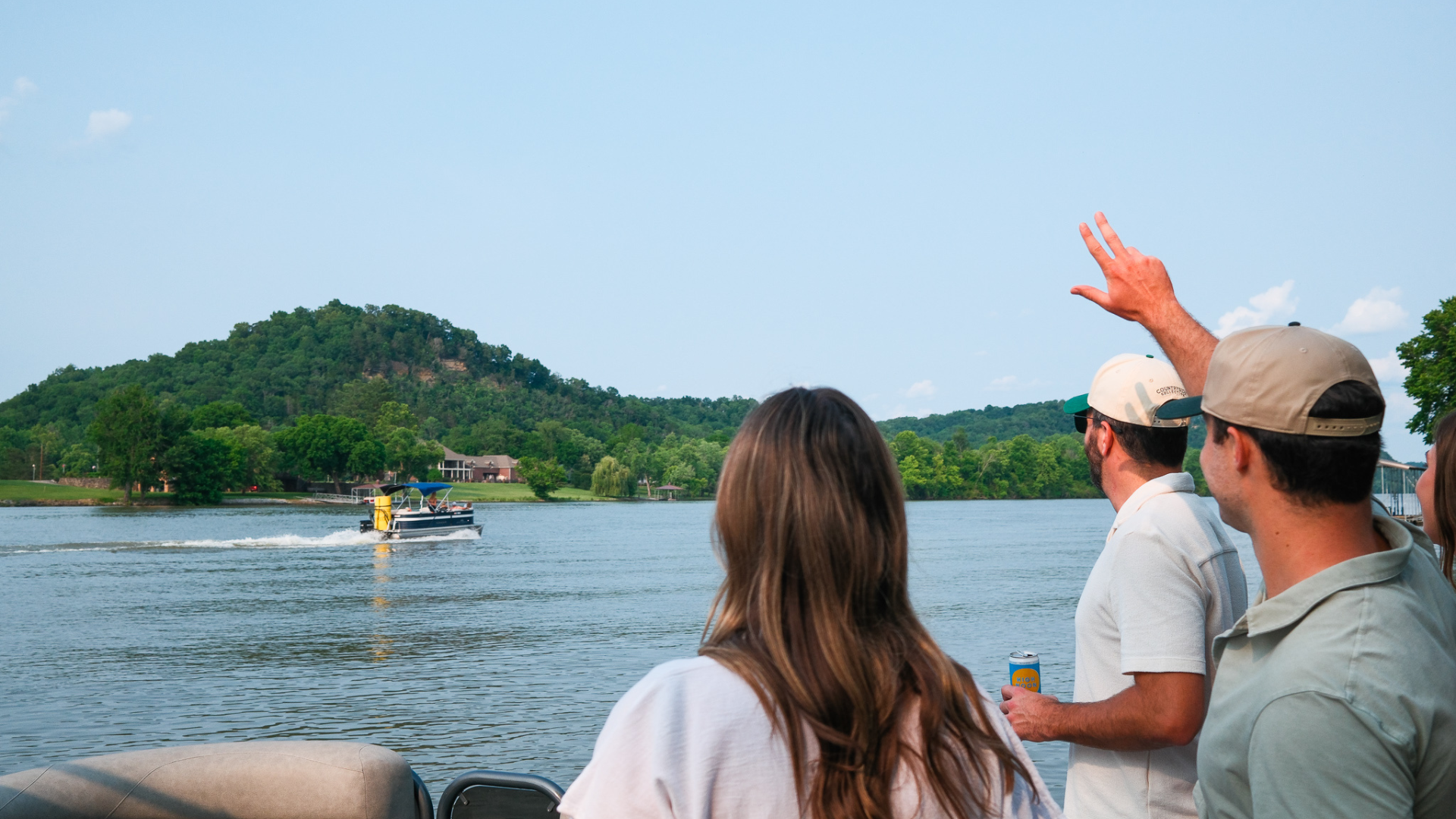 people waving at another boat passing by in nashville