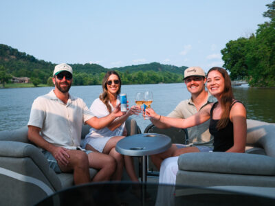 group of people cheersing on a boat rental in nashville