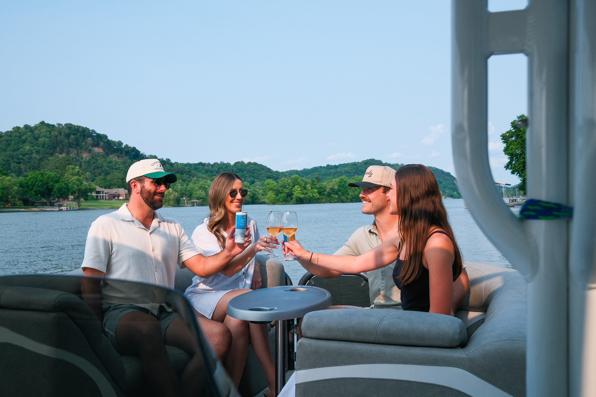group of people cheersin on a boat rental in nashville